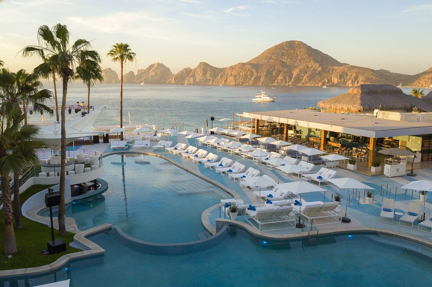 The pool terrace at ME Cabo, overlooking the bay and Land’s End rock formations.
